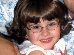 photo of a 3 year old girl wearing glasses