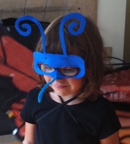 Zoe in her butterfly mask.